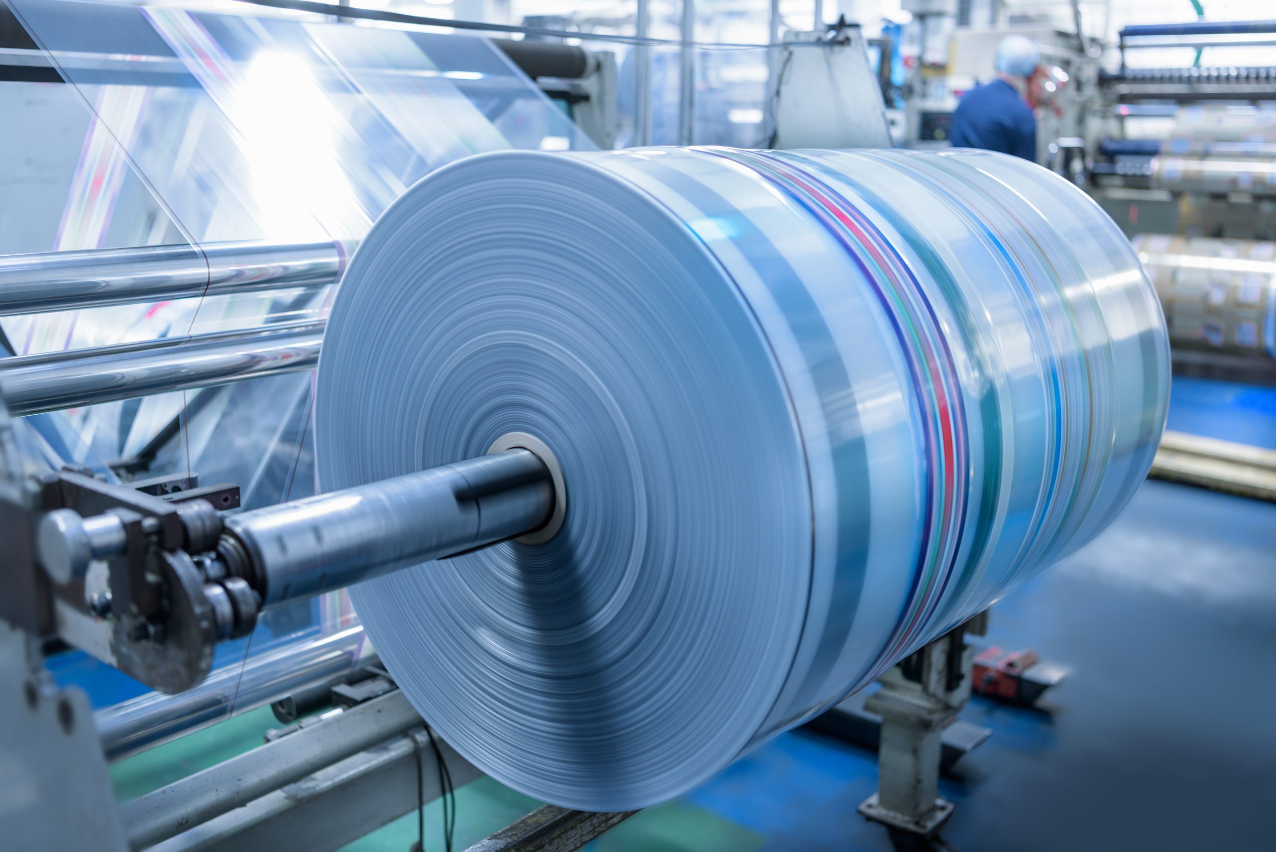 Spinning roll of printed packaging in food packaging printing factory